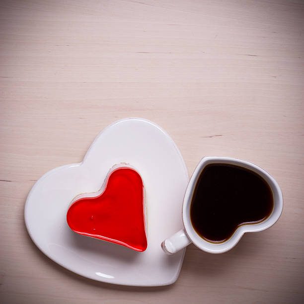 istock Heart shaped coffee cup and cake on wood surface 481188618