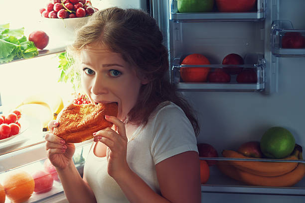 istock Woman eats night stole the refrigerator 481190118