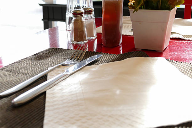 istock fork,knife, honey, pepper and salt on red table 481192890