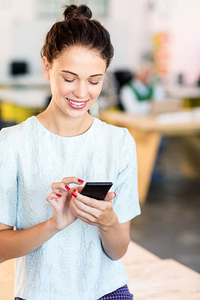 istock Businesswoman Text Messaging Through Smart Phone 481197412