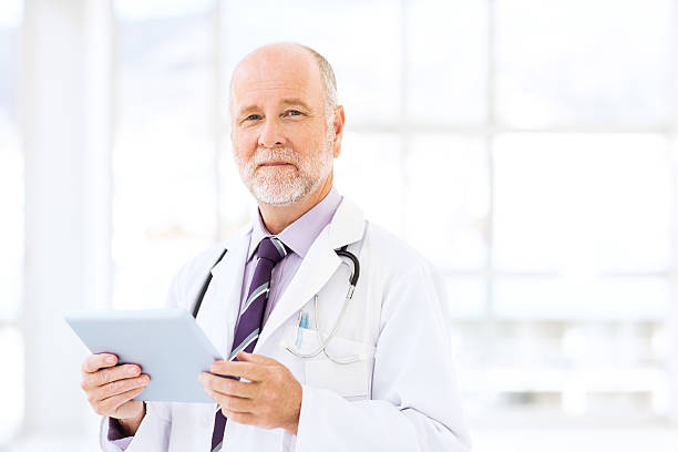 istock Confident Doctor Holding Digital Tablet 481197484