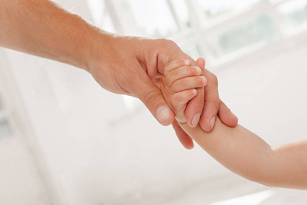 istock father giving hand to a child 481197966
