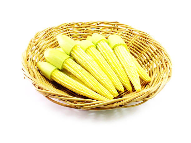 istock baby corn on wooden basket over white background 481199054