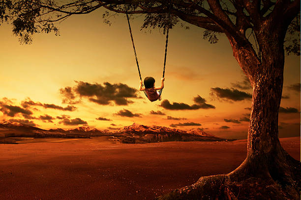 istock little girl on a swing with sunset background 481199382