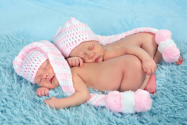 istock Newborn twins with pink hats 481199569