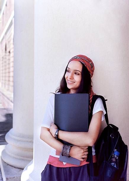 Portrait of a happy Indian / Asian college student in campus.