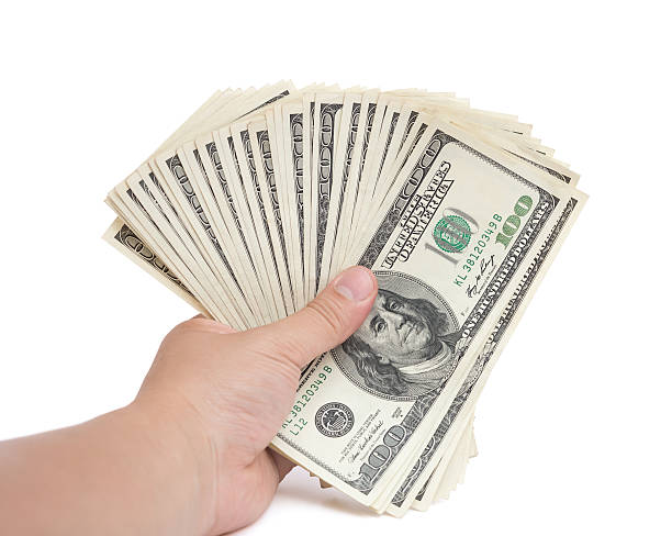 istock hand holding stacks of 100 USD paper currency 481202640