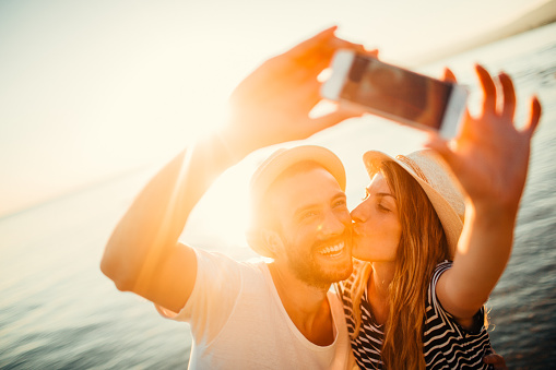 Young smiling couple making a selfie and capturing great moment on their vacation