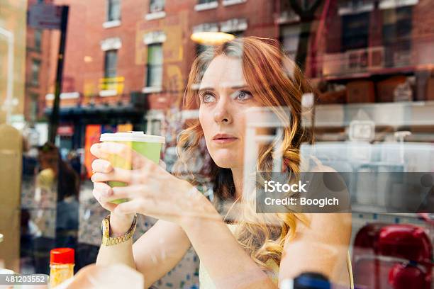 Nyc Woman Drinking Coffee Looks Out Window At Cafe Restaurant Stock Photo - Download Image Now