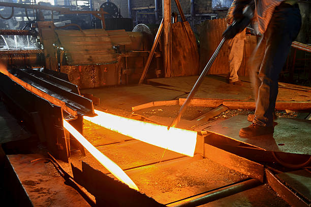 istock Man holding hot steel on conveyor band 481204417