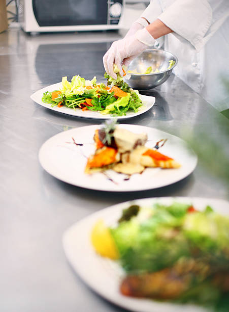 istock Professional chef places finishing touches on meal 481204603