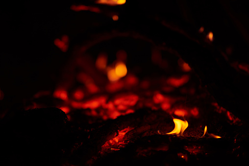 selective focus of flame near fire camp, night time.