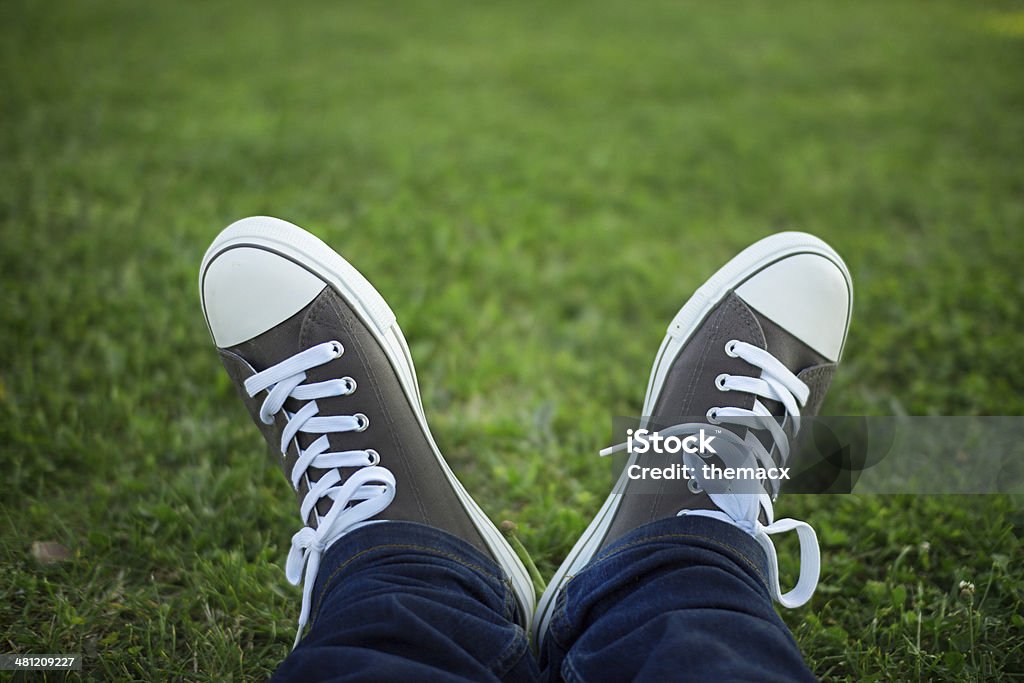Canvas shoe Canvas shoe with fresh grass. Adult Stock Photo