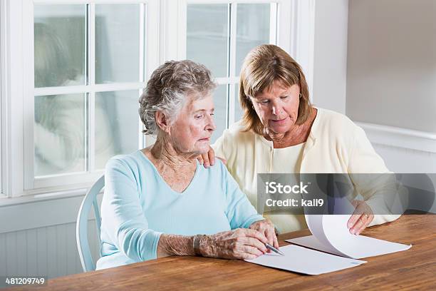 Elderly Woman Reading Paperwork Stock Photo - Download Image Now - Senior Adult, Document, Legal System