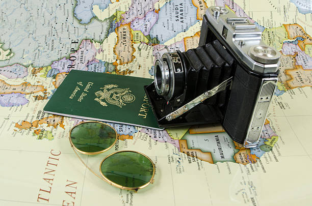 istock Antique Bellows Camera, USA Passport, and Map 481210291