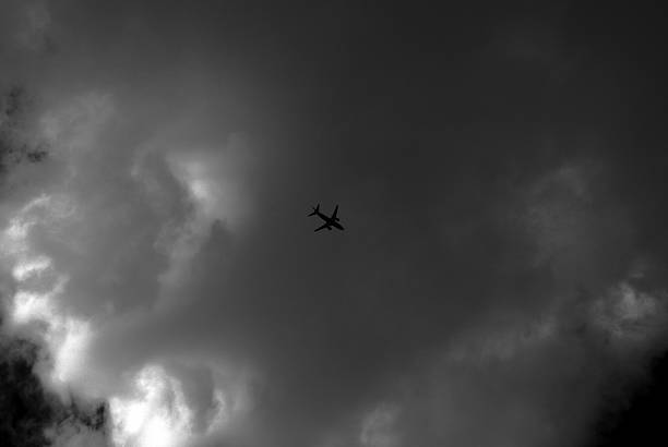 istock Airliner silhouette on Clouds Black and White 481211245