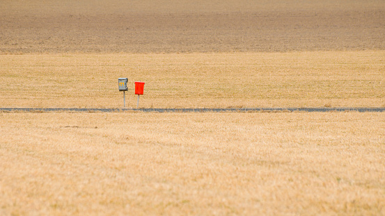 Two old mailboxes on a country road.