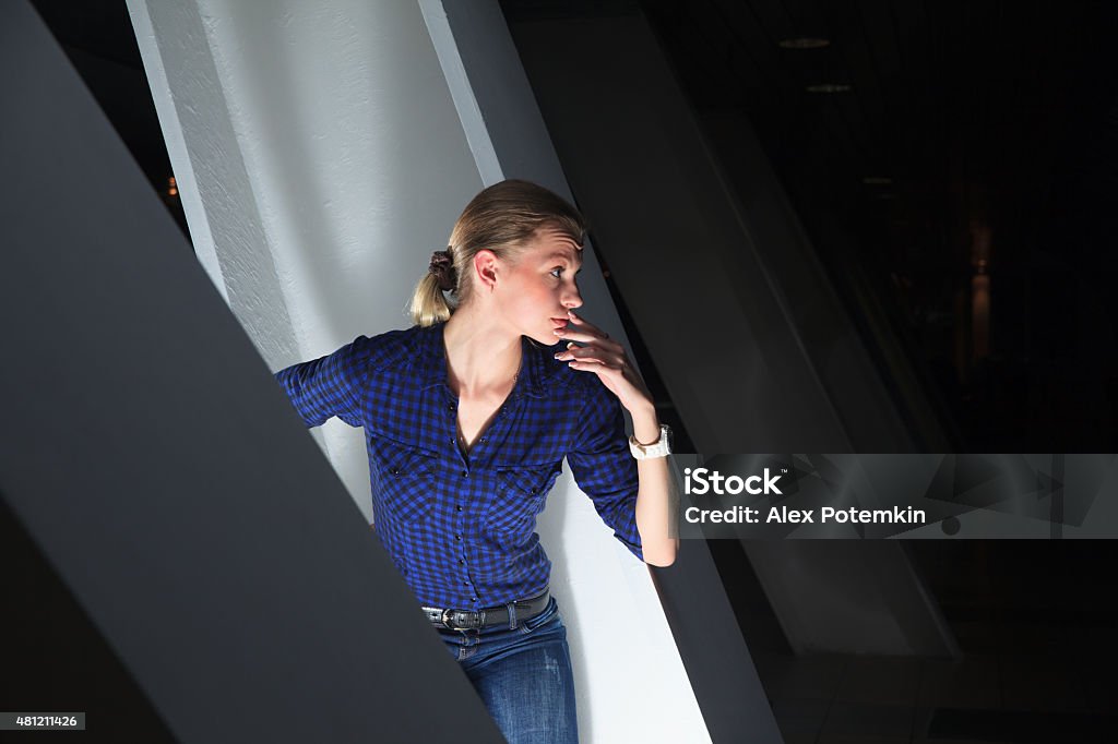 Portrait of young woman in the dark environment Portrait of young long-haired caucasian russian woman in the dark environment 2015 Stock Photo