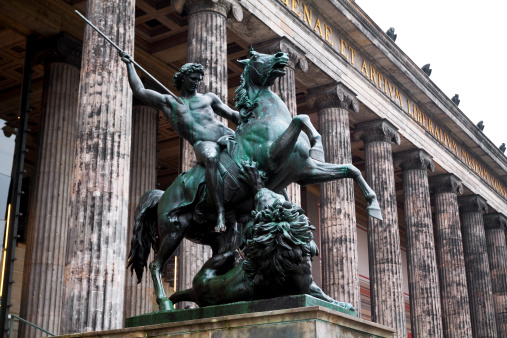 Berlin, Germany - October, 27th 2011: Altes Museum Berlin, focus on equestrian statue with rider throwing lance towards lion. Musuem was built in early 19th century by Schinkel.