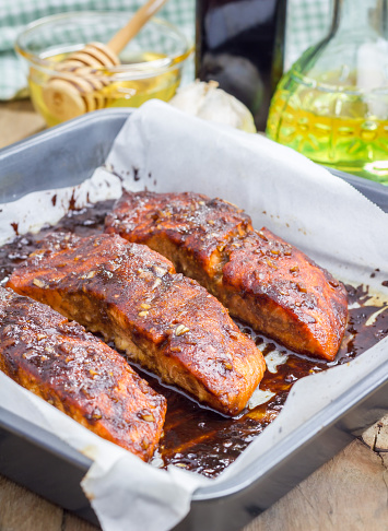 Salmon fillet with balsamic-honey sauce in baking dish, baked