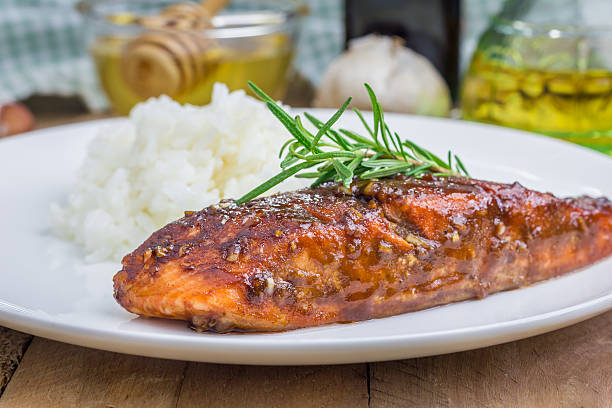 Baked salmon fillet in balsamic-honey sauce with rice stock photo