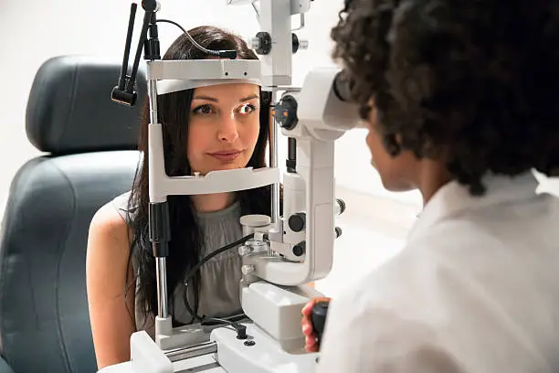 A patient is having an eye exam at the optometrist office.   http://amrimage.com/blog/wp-content/uploads/2014/03/Optometrist.jpg