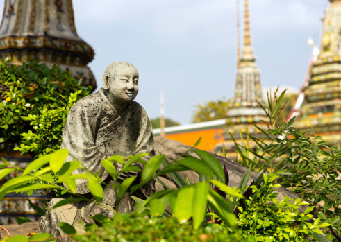 Ancient monk statue in the garden og Wat Po Temple