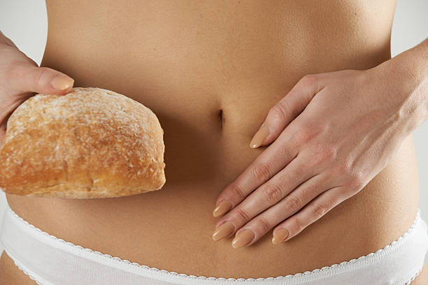 Close Up Of Wheat Intolerant Woman Holding Bread stock photo