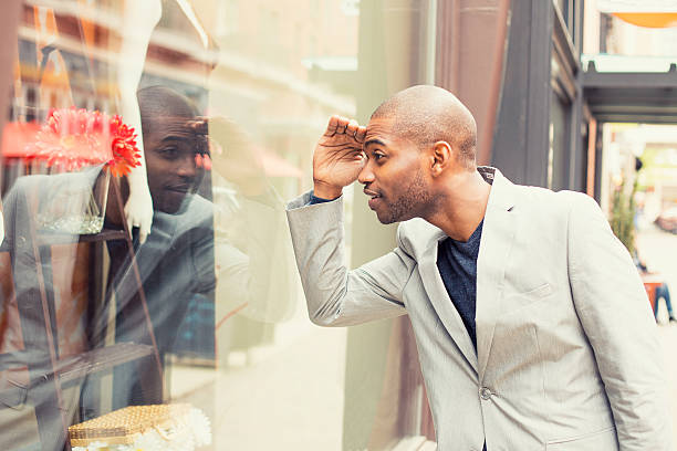 bell'uomo in cerca di nuovi vestiti. shopping tempo - guardare le vetrine foto e immagini stock