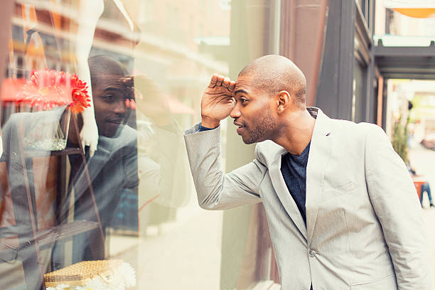 Handsome man looking for new clothes. Shopping time Happy handsome man looking for new clothes. Shopping time window shopping stock pictures, royalty-free photos & images