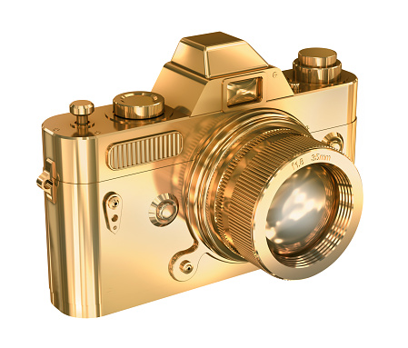 Gold photo camera on a white background