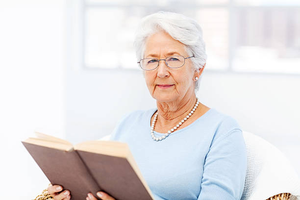 istock Beautiful Senior Woman Holding Book 481217030