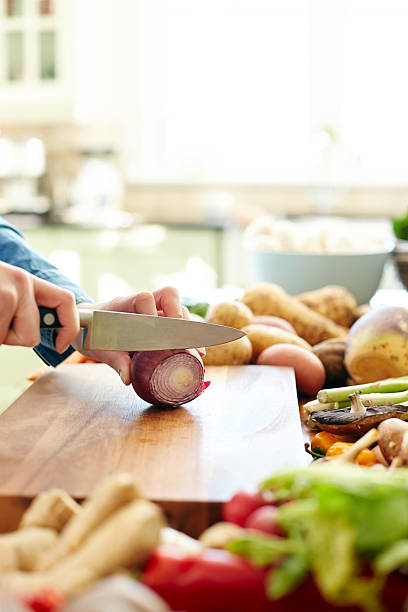 istock Cropped image of female hands chopping onion 481217184