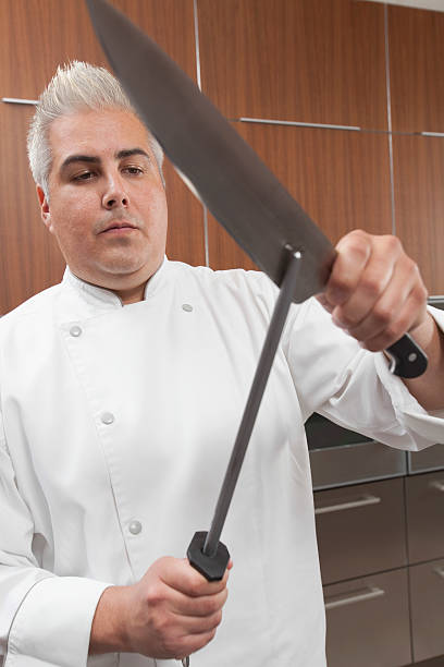 istock Chef Sharpening Knives In Commercial Kitchen 481219731