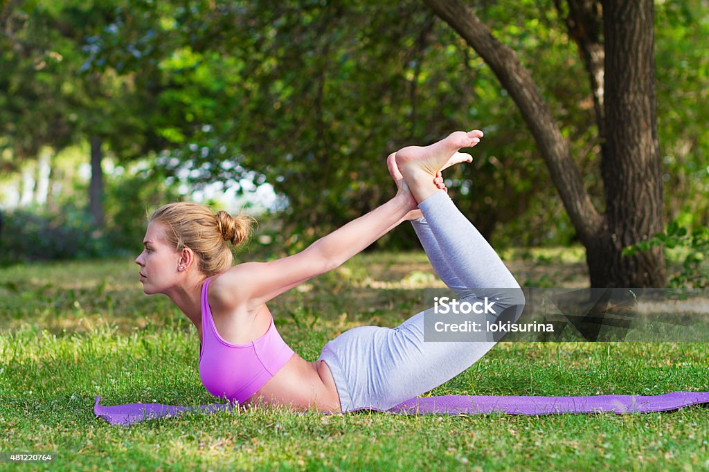 girl doing yoga and gymnastics on the grass 2015 Stock Photo