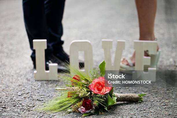 The Word Love And A Bouquet Of Flowers Stock Photo - Download Image Now - 2015, Beach, Bouquet
