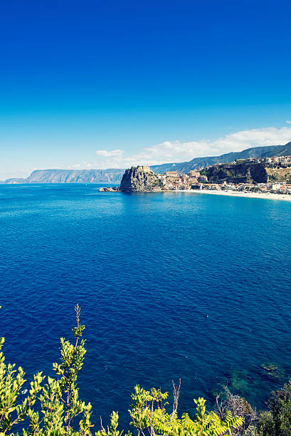 Calabrian coastline with the town of Scilla Looking at Scilla, a town located in the province of Reggio Calabria in Southern Italy. View on the rock with the Ruffo Castle and the beach front. castle scilla stock pictures, royalty-free photos & images