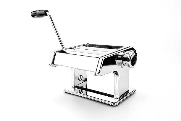 Image of a modern pasta maker with black handle made from stainless steel against a white background.