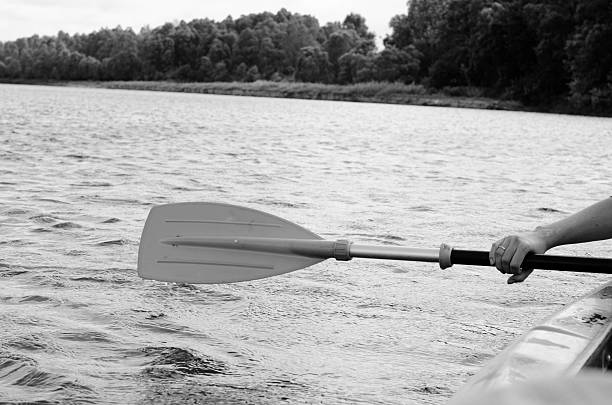 Rowing, holding a kayak paddle