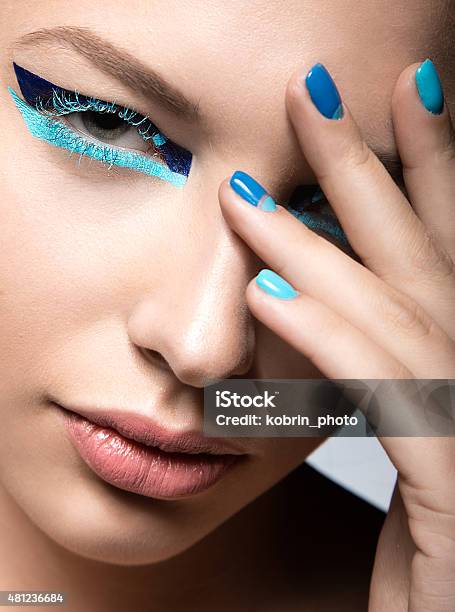 Beautiful Girl With Bright Creative Fashion Makeup And Blue Nail Stock Photo - Download Image Now