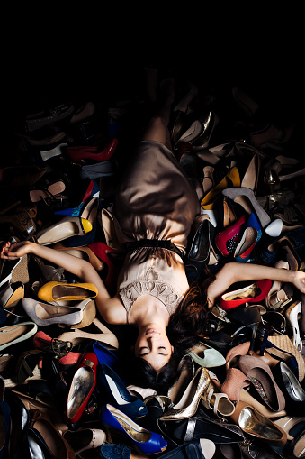 Woman lying on high heels in a store