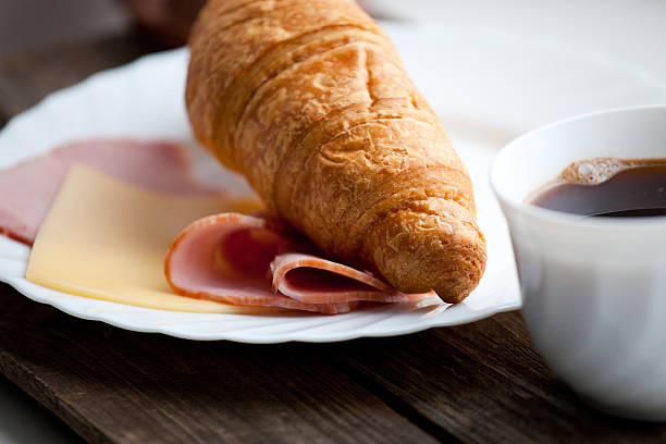 istock Continental breakfast with croissant and coffee 481239744