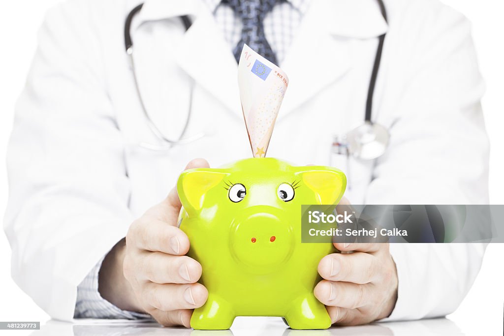 Medicine, healthcare and all things related Medical doctor holding piggy bank as an idea for healthcare insurance and savings for medical expenses Adult Stock Photo