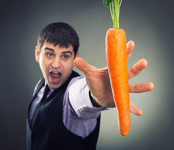 istock Man trying to reach carrot 481239887