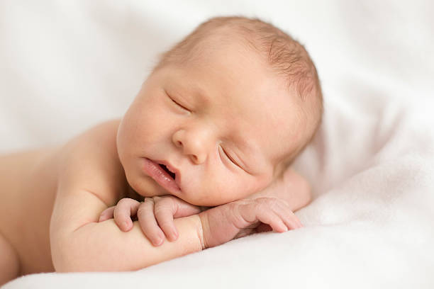 istock newborn baby sleeping in the arms 481242164