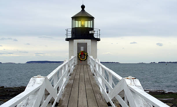 Decorated for the Holidays Marshall Point Lighthouse, located Port Clyde, Rockland Maine.  The lighthouse is decorated for Christmas holiday season. lighthouse maine new england coastline stock pictures, royalty-free photos & images