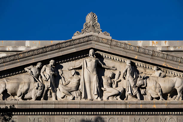 A Three Fates sculpture on the facade of an elegant building in Wenceslas Square, Prague, Czech Republic.