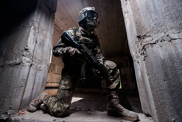 istock Trooper in military camouflage holding a gun 481243954
