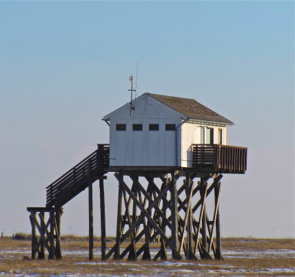 House on poles, Norther Germany, coast on the Northern Sea. Winter, no water.