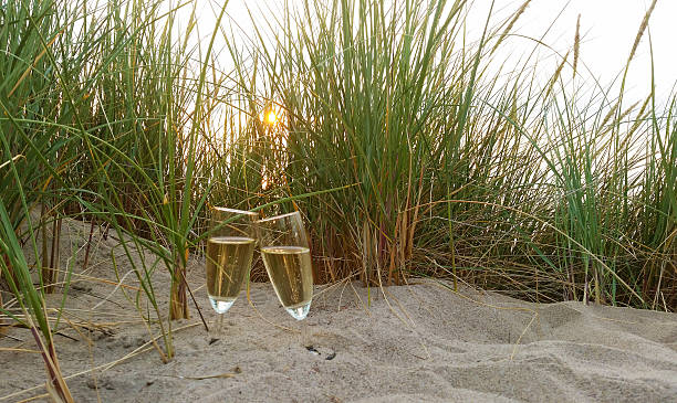 Two Cups of champagne or cava in the sand. stock photo
